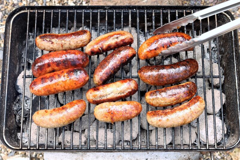 Wescountry sausages sizzling on a BBQ